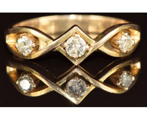 A 14k gold ring set with three diamonds, the largest approximately 0.1ct, 2.7g, size N