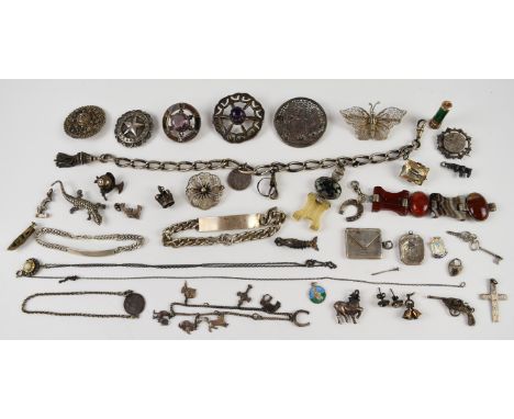 A collection of silver including Victorian Albert with tassel charm, two bracelets, twelve charms, stamp holder, charm bracel