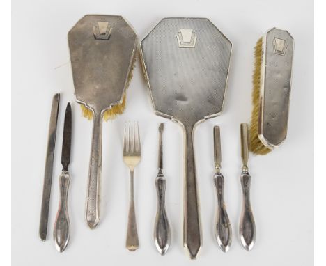 Art Deco hallmarked silver dressing table set comprising hand mirror, two brushes and comb mount, Birmingham 1939, maker Davi