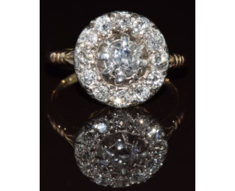 An 18k gold ring set with a cluster of old cut diamonds, the centre diamond approximately 0.5ct, 4.9g, size N