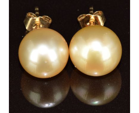 A pair of 18k gold earrings, each set with a cultured pearl