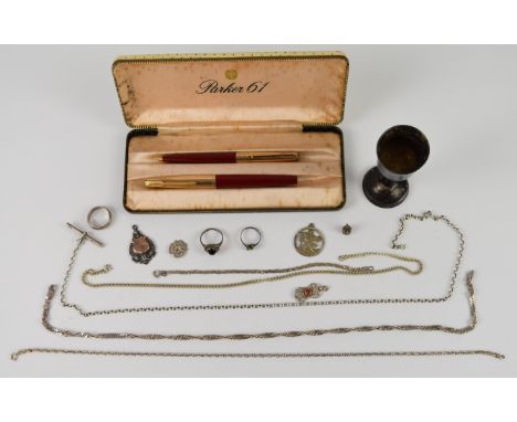 A collection of silver jewellery including curb link necklaces, three rings, chain, T bar, St Christopher, fob, bracelet, cup