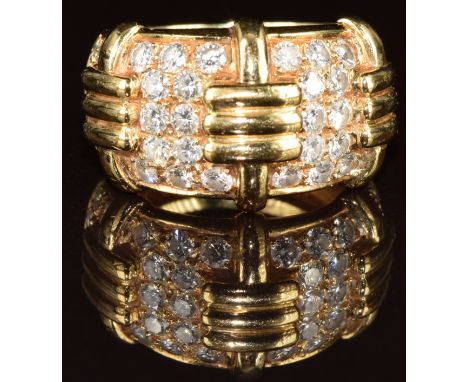 An 18K gold ring set with 36 round cut diamonds graduating from 0.05ct to 0.02ct, total diamond weight 1.5ct, in four panels,