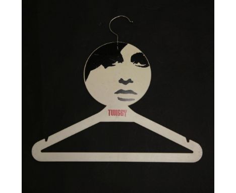 A Twiggy 'London Girl' plastic coat hanger, 1967lithographed image of Twiggy's portrait,40cmThis was given away with every ga
