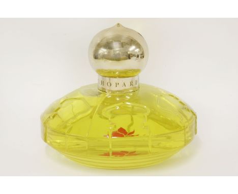 A Chopard 'Casmir' display scent bottle with contents,in a glass dome shaped scent bottle with shaped base, gilt-tone round s