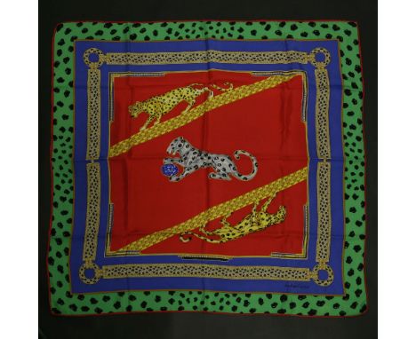 A Must de Cartier silk scarf,multicoloured ground with a printed design of the classic panthers on a jewellery design