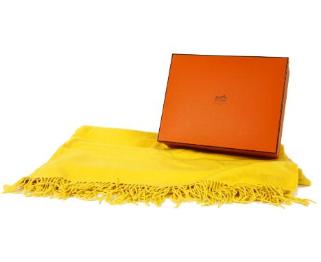 An Hermès of Paris yellow cashmere fringe blanket,embroidered 'HERMES', 100% cashmere, c.1990, in original tissue paper, ribb