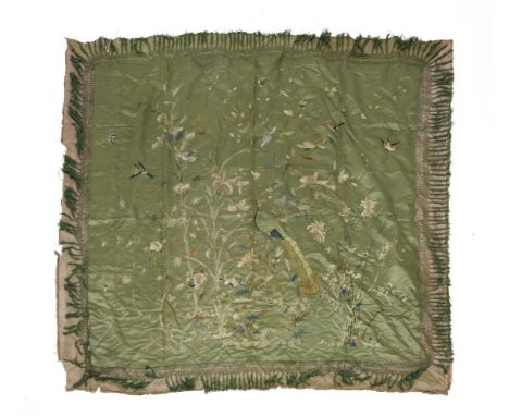 A 19th century oriental green silk piano shawl,highly embroidered with a peacock, butterflies and birds in a naturalistic set