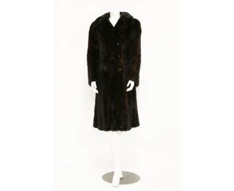A dark brown mink fur coat,with red taffeta lining and gilt and black button-up front,size 12-14 (approximately)