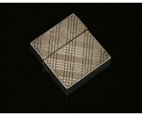 A Tiffany & Co. silver cigarette lighter, with milled geometric decoration, the base stamped 'Sterling, Tiffany & Co'