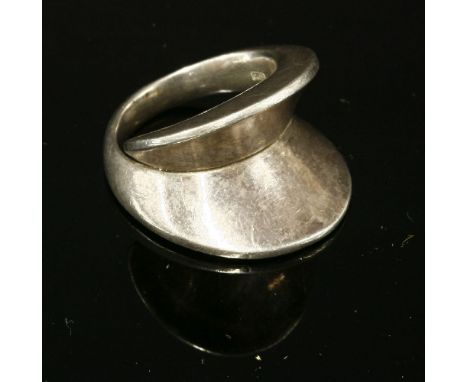 A sterling silver ring by Georg Jensen,no.93, designed by Nanna Ditzel, with deeply angled head to slightly crossover shoulde