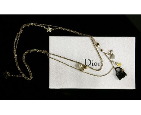 A Christian Dior two-row gold-plated chain necklace,with assorted charms to include a black miniature Lady Dior handbag and a