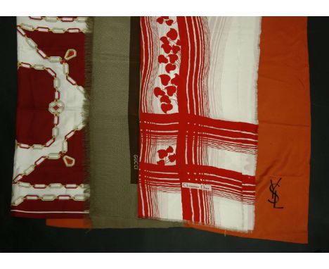 A Gucci brown silk scarf,with printed design and tassel edging,a Must de Cartier red silk scarf,with printed necklace design,