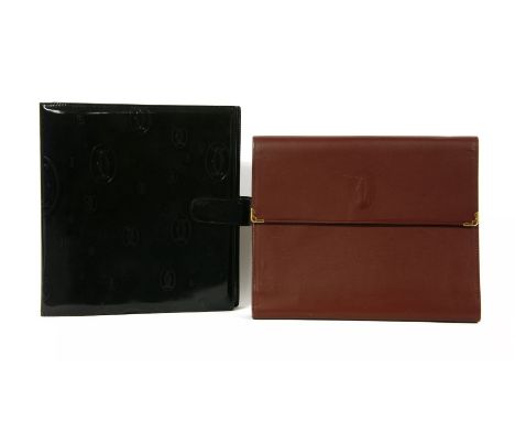 A Cartier red bordeaux leather address holder,embossed logo to front, sectioned interior and ring binder, stamped 'Cartier Pa