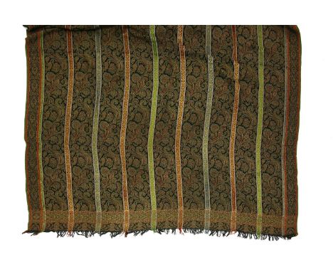A large wool shawl,late 19th/early 20th century, a black ground with woven paisley design, coloured banding and with a tassel