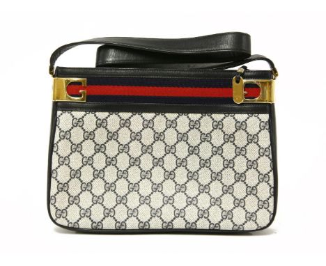 A Gucci vintage handbag,with navy blue leather and monogrammed canvas, techno banding and gold-tone hardware