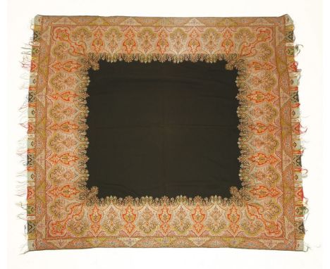 A mid-19th century woven paisley shawl,in predominantly red and orange tones with central black panel reserve and a tassel ed
