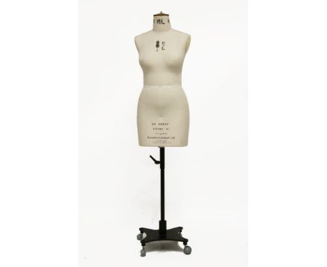 A Kennett and Lindsell female dressmaker's mannequin,covered in the maker's classic cream linen with adjustable shoulders, ma