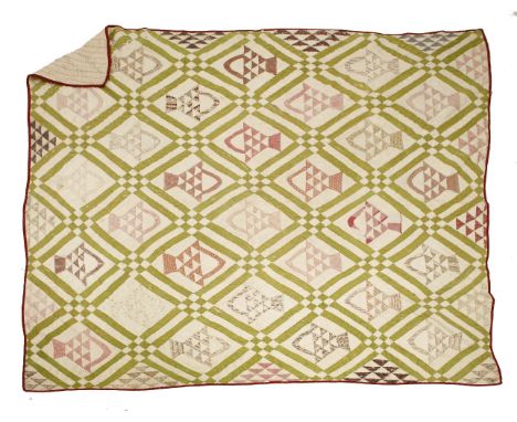 An American patchwork quilt,late 19th to early 20th century, green and cream ground with triangular and arrow-shaped patches 