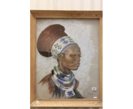 Tribal Art; a framed pastel and chalk portrait of an African woman in tribal dress; signed and dated