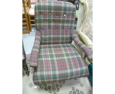 A beech framed open button back armchair, raised on turned supports, terminating in brass castors