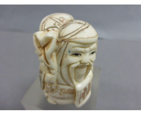 Signed Oxbone netsuke of an old man with sack