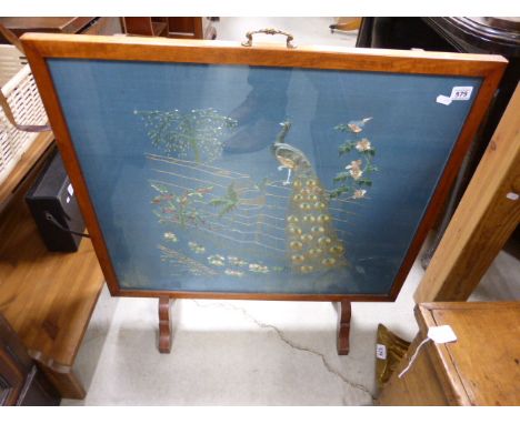 A maple framed fire screen with peacock decoration