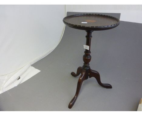 A small inlaid mahogany tripod wine table