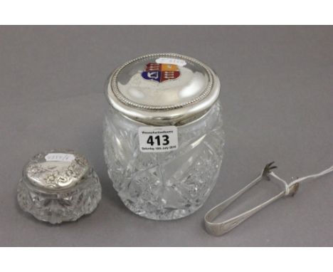A pair of George V silver sugar tongs; in the form of talons; Sheffield 1923; together with a silver lidded glass dressing ta