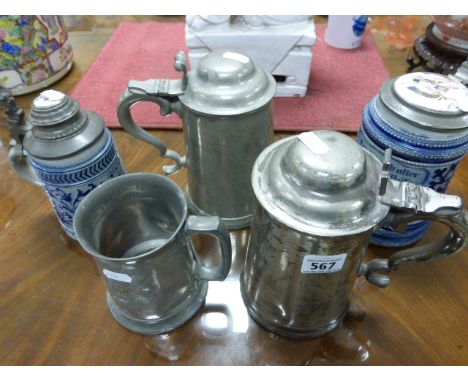 Two German pottery beer steins, each with pewter and enamel lids; together with two pewter lidded beer steins and a pewter ta