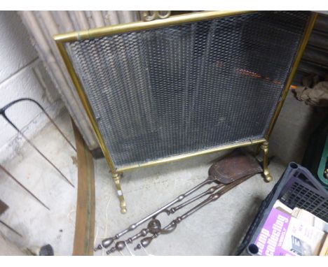 A cast iron three piece fireside companion set together with a brass firescreen