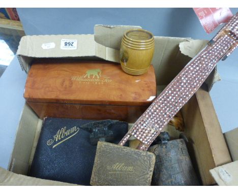 A box of various collectibles to include; a tea caddy, various Black Forest items and two albums of poems