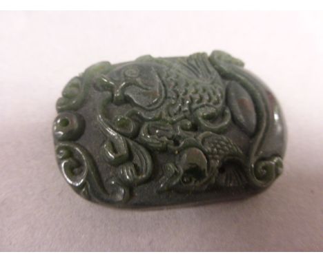 A Chinese Jade carved disc depicting koi carp