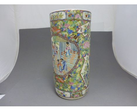 A Chinese porcelain cylindrical stick stand; richly coloured with figures in a court scene on a floral painted ground