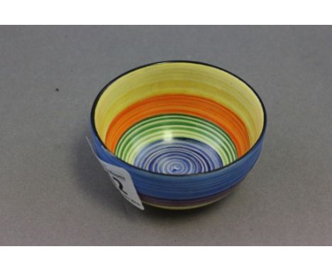 A small Carltonware pottery bowl; with swirling bands of different colours; bearing black script and 0/4599 mark to base