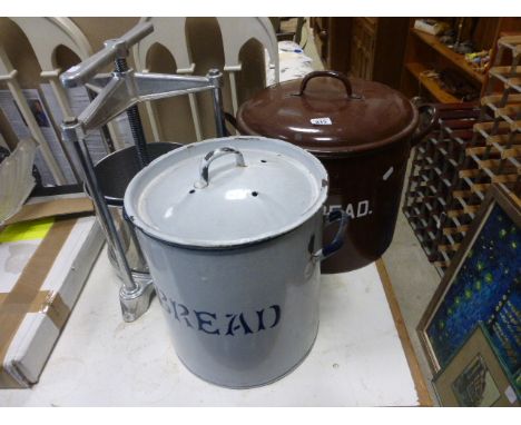 Two painted enamel bread bins together with a vintage mincer
