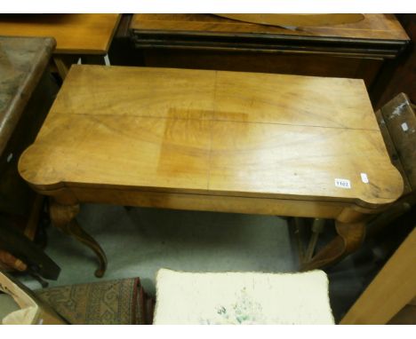 A George III mahogany fold over card table; opening to reveal baize interior; raised on four cabriole supports