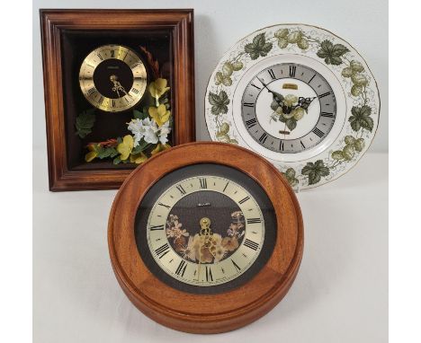 3 vintage Metamec quartz wall hanging clocks. 2 wooden cased clocks with floral detail together with a Royal Worcester 'Matho