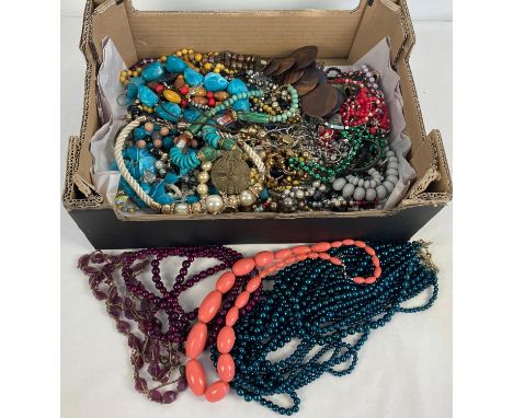 A box of vintage and modern costume jewellery. To include faux pearl statement necklace, rings and bracelets. 