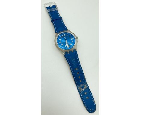 A unisex S216 Swatch watch with metallic blue face and original blue leather strap. Luminescent number markers and hands, som