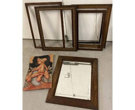 A collection of vintage wooden picture frames together with a dark oak framed mirror and a carved wooden wall plaque. 