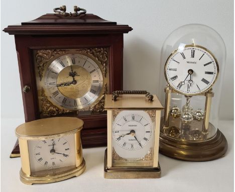 4 vintage Metamec quartz clocks. To include a wooden cased brass faced mantel clock, an small gold tone carriage clock and a 