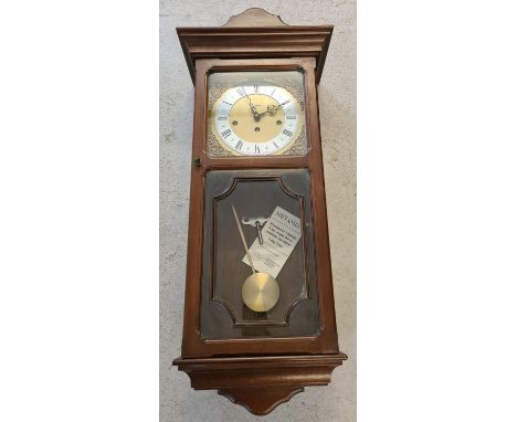 A vintage wooden cased Metamec Westminster chiming, 8 day weight driven wall clock. Complete with pendulum, key and original 