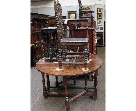 An 18th Century Oak Gate Leg Dining Table, 144cm by 119cm by 73cm, together with a carved oak lamp table, similar drop leaf t