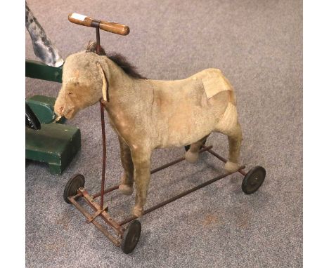 A Steiff Donkey on Wheels, circa 1930, straw filled and with steering bar