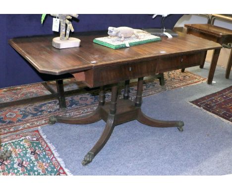 A 19th Century Crossbanded Mahogany Sofa Table, on four turned supports, over a platform issuing four reeded downswept legs, 
