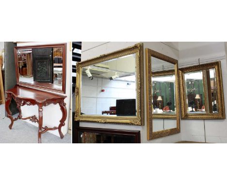 A Reproduction Carved Mahogany Console Table, with serpentine front, 110cm by 45cm by 77cm and a similar mirror, 100cm by 70c