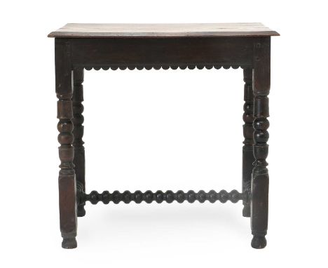 An Oak Side Table, the moulded top above a moulded and carved frieze, on bobbin-turned supports with block feet joined by a t