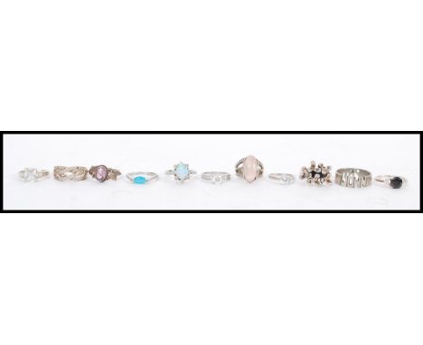 A collection of 11 silver rings to include white stone, onyx, blue stone, opal, purple stone etc. Total weight 52.9 grams.