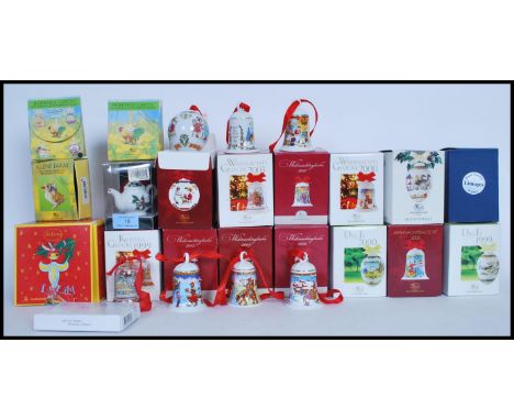 A collection of ceramic and crystal Christmas decorations modelled as bells, each from a different year with different design